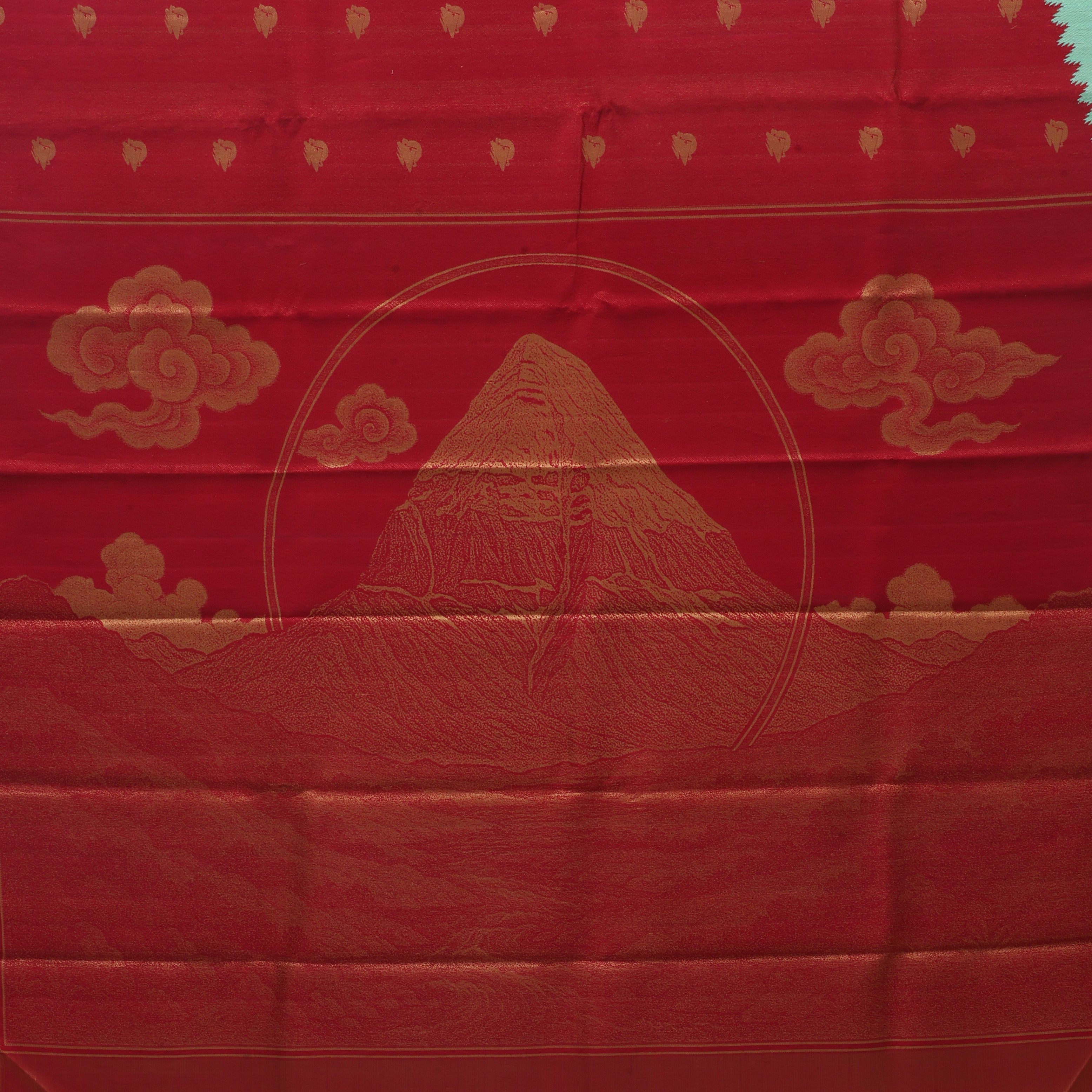 Crimson red gold zari Kailash hills design contrast pista green raising design border trendy signature silk saree