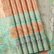 Honey orange silver zari floral creeper design contrast parrot green border grand bridal tissue silk saree