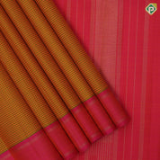 orangish yellow with leaf green lines and thread works design plain rose pink gold zari rettapettai border traditional retro silk saree