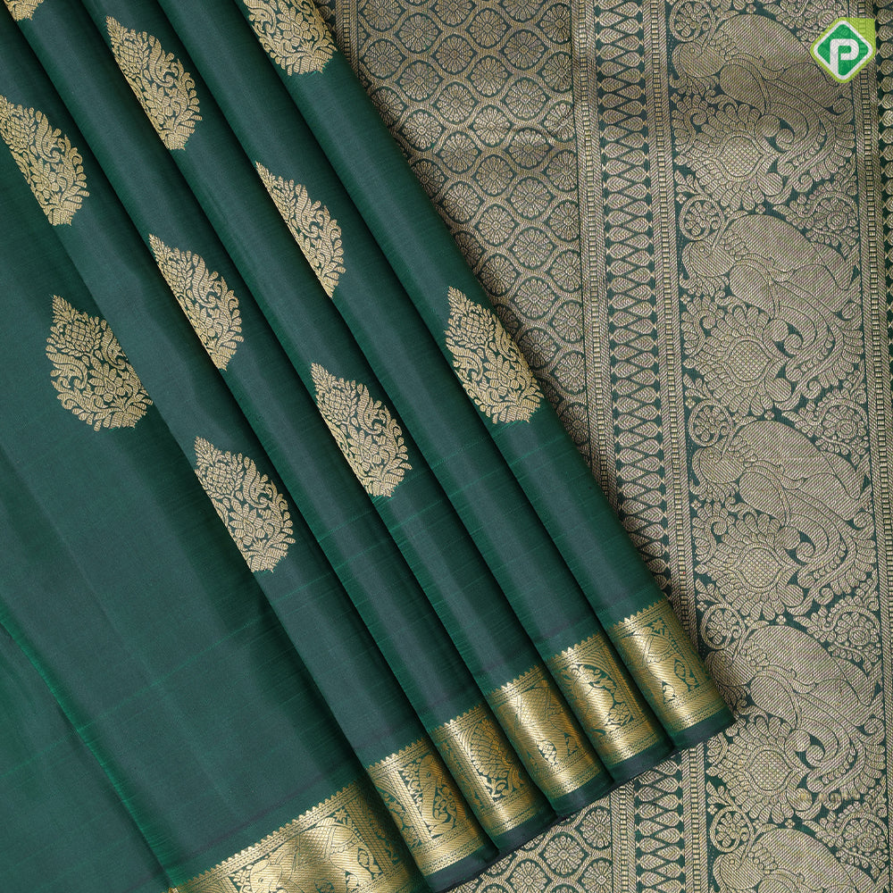Bottle green gold zari fancy thilagam butta design self color gold zari peacock elephant butts edge border traditional silk saree