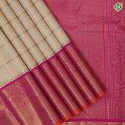 creamy sandal gold zari grand buttas filled checks contrast pink gold zari double peacock arch design border grand bridal silk saree