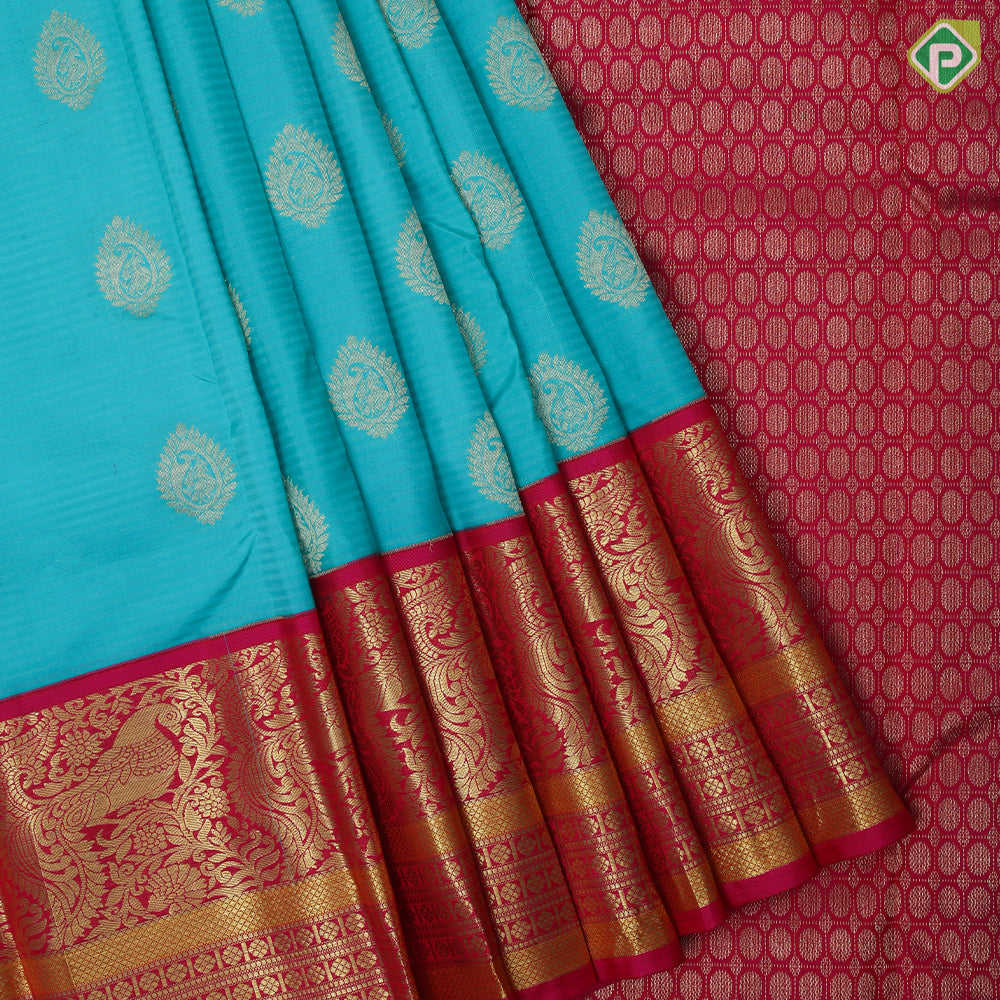 Sea green gold zari thilagam butta contrast pink gold zari peacock border traditional silk saree