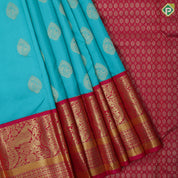 Sea green gold zari thilagam butta contrast pink gold zari peacock border traditional silk saree