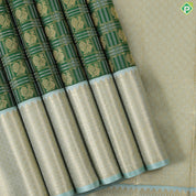 Dark green with peacock butta silver and gold zari checkered sea foam green border traditional silk saree