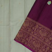 Pista green self designed stripes gold zari chakkaram butta contrast purple gold zari double peacock banaras style border fusion silk saree