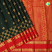 Deep green gold zari flower butta design contrast chilly red gold zari rettapet border grand bridal silk saree