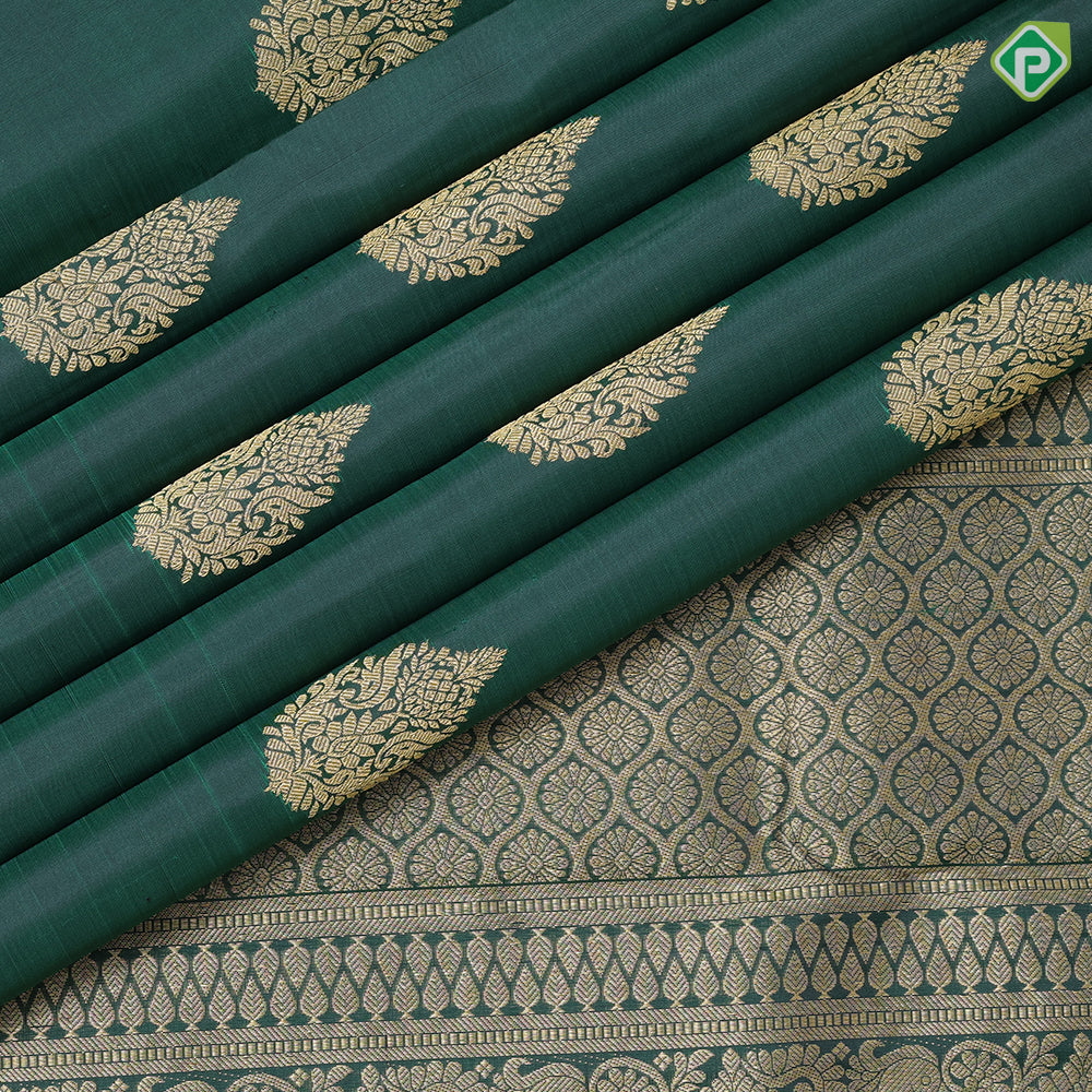 Bottle green gold zari fancy thilagam butta design self color gold zari peacock elephant butts edge border traditional silk saree
