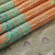 Honey orange silver zari floral creeper design contrast parrot green border grand bridal tissue silk saree