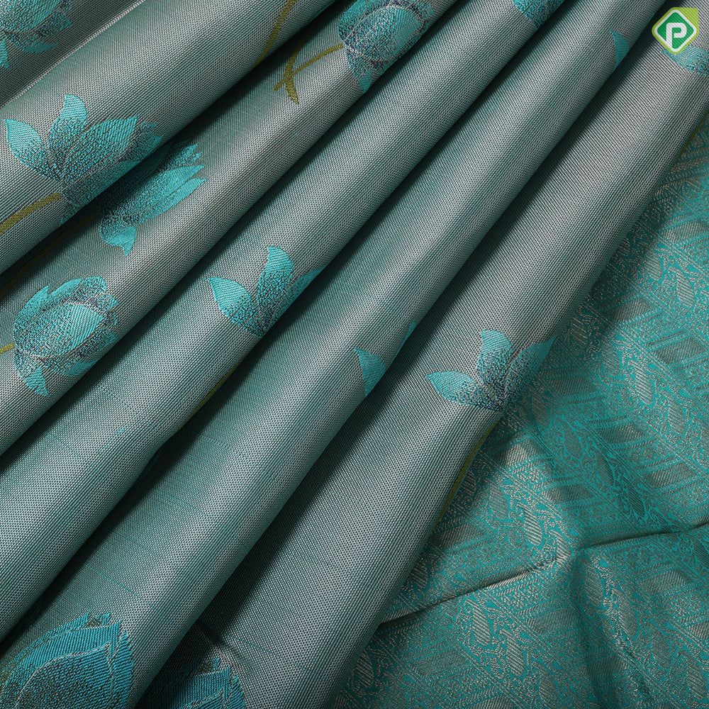 greyish green lotus flower embossed design peacock green gold zari border trendy silk saree