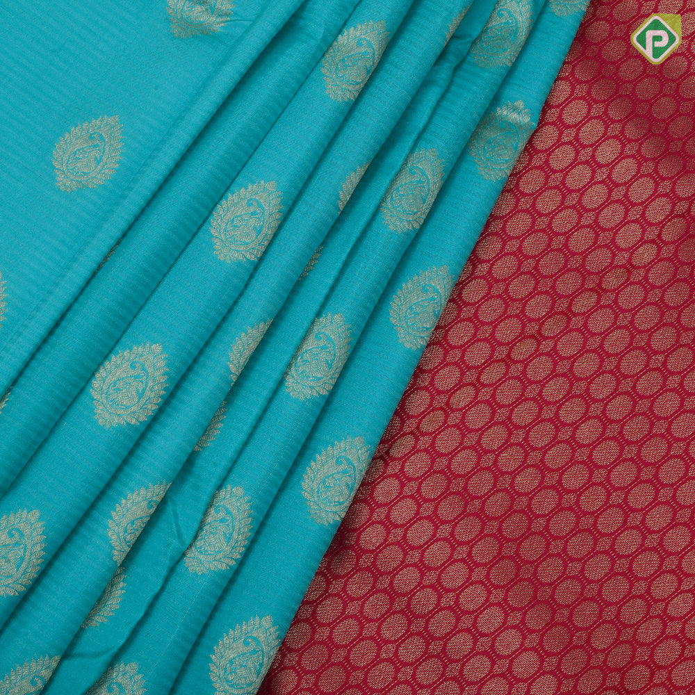 Sea green gold zari thilagam butta contrast pink gold zari peacock border traditional silk saree
