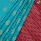 Sea green gold zari thilagam butta contrast pink gold zari peacock border traditional silk saree