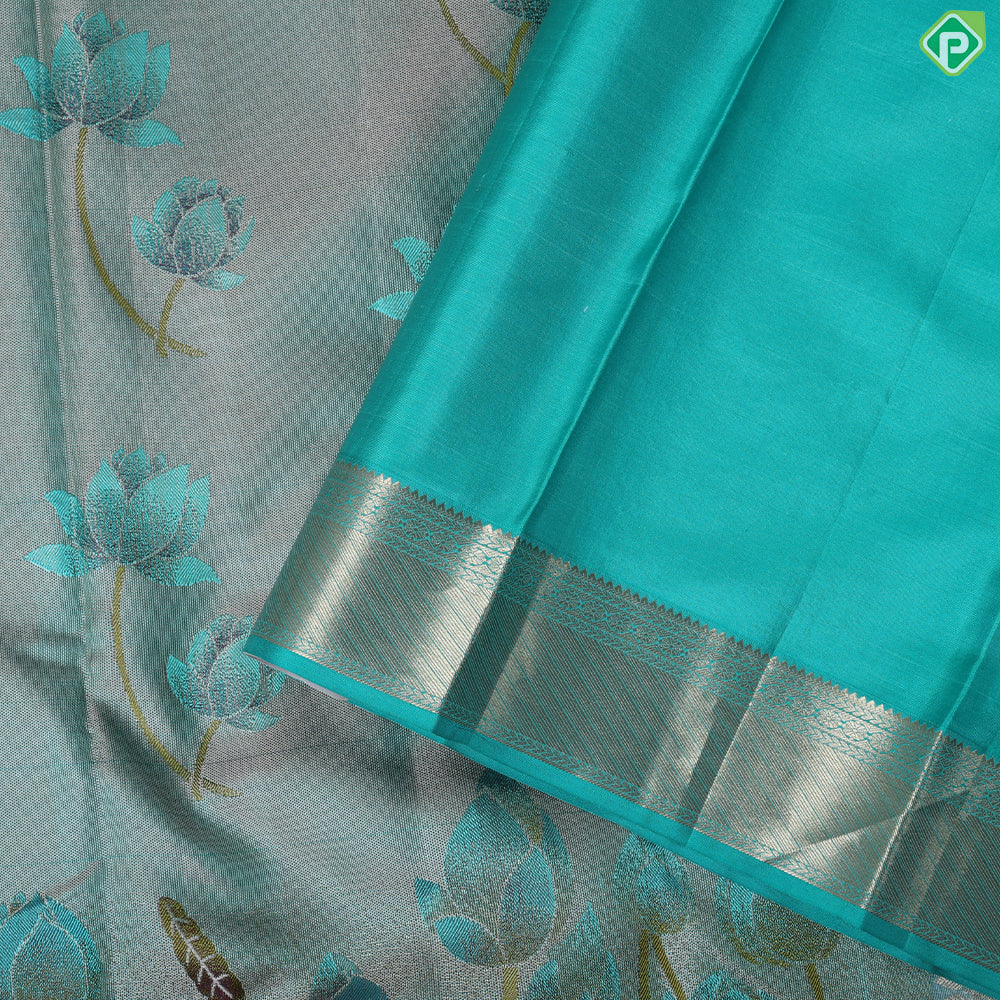 greyish green lotus flower embossed design peacock green gold zari border trendy silk saree