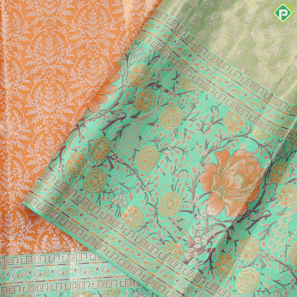 Honey orange silver zari floral creeper design contrast parrot green border grand bridal tissue silk saree