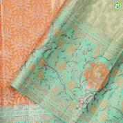 Honey orange silver zari floral creeper design contrast parrot green border grand bridal tissue silk saree