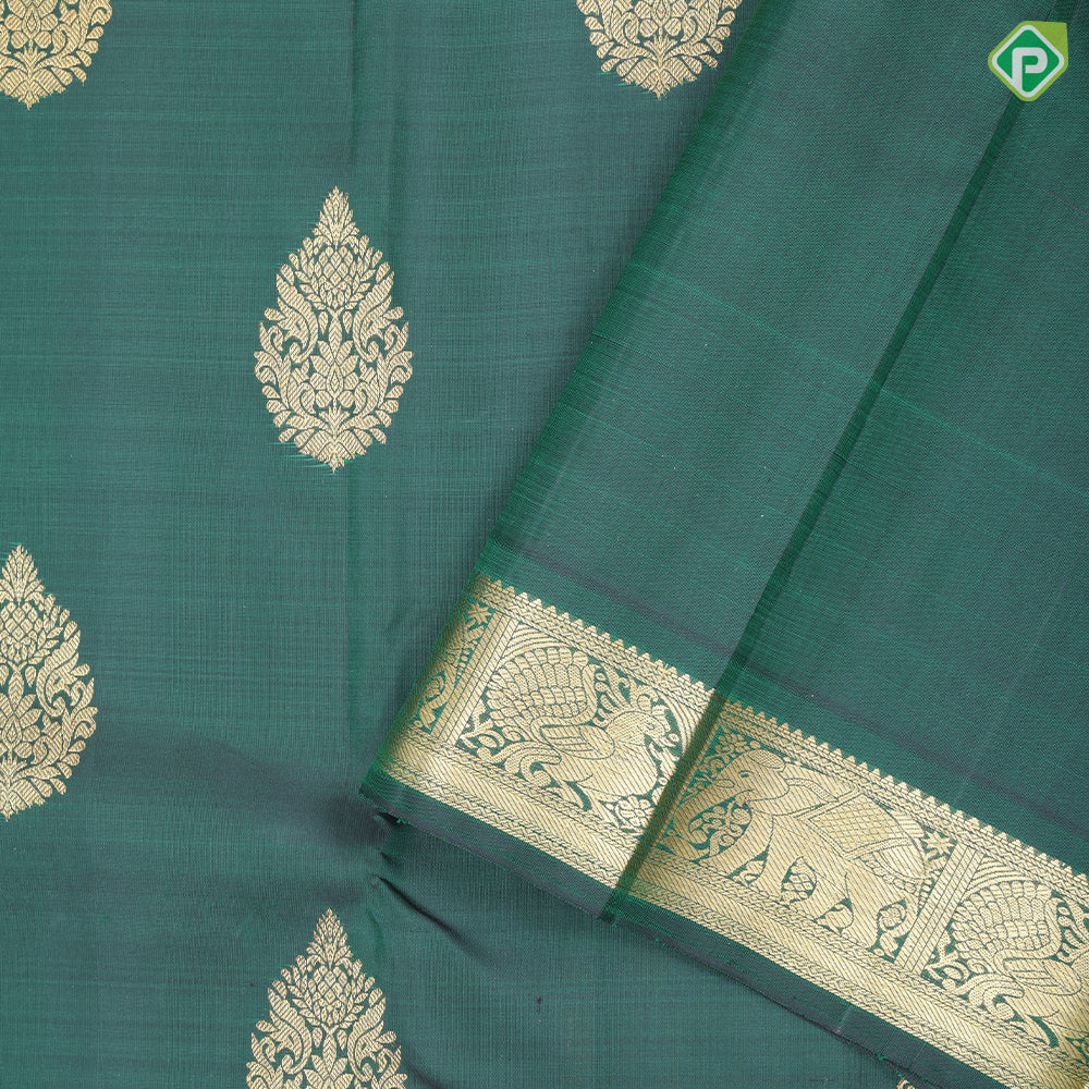 Bottle green gold zari fancy thilagam butta design self color gold zari peacock elephant butts edge border traditional silk saree