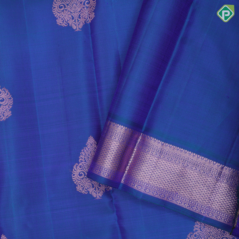 Peacock blue copper zari fancy thilagam butta design self color copper zari spinning edge border traditional silk saree