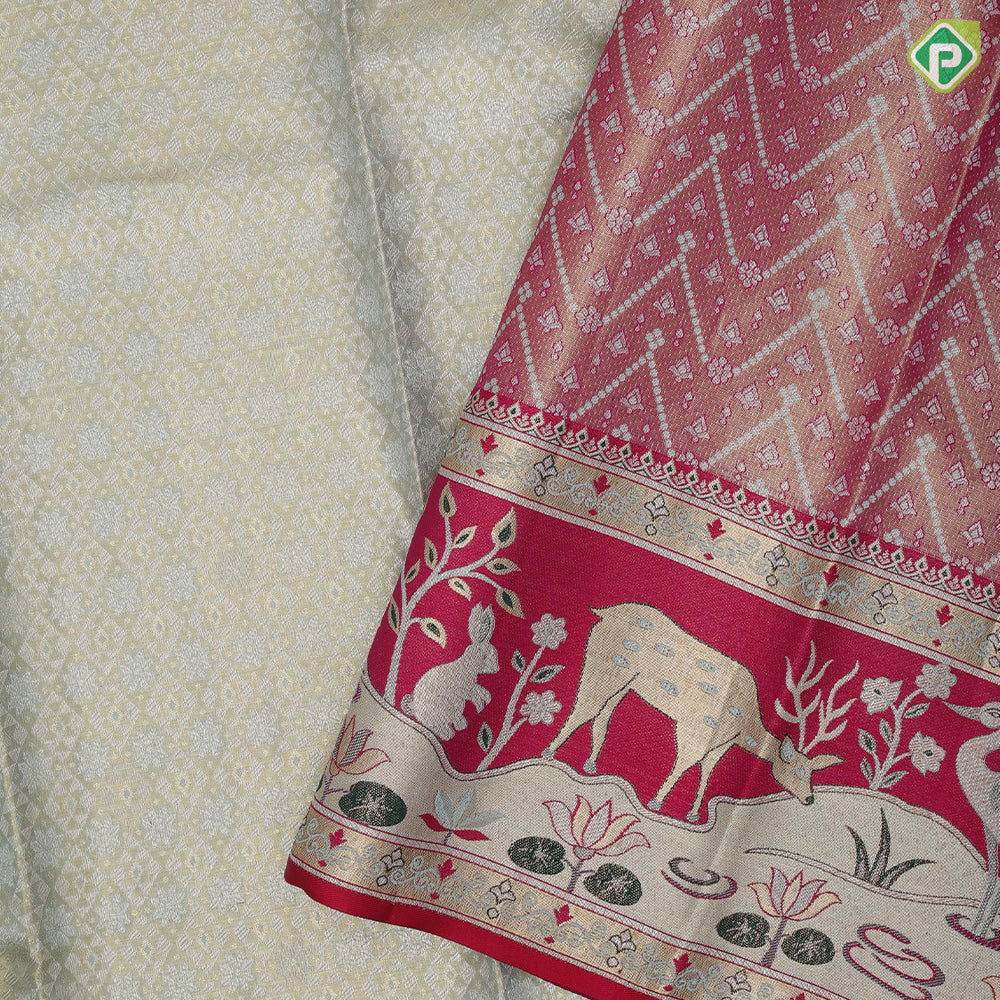 Mint green silver gold zari geometrical brocade design contrast rani pink gold zari wild effect pythonic design border grand tissue silk saree