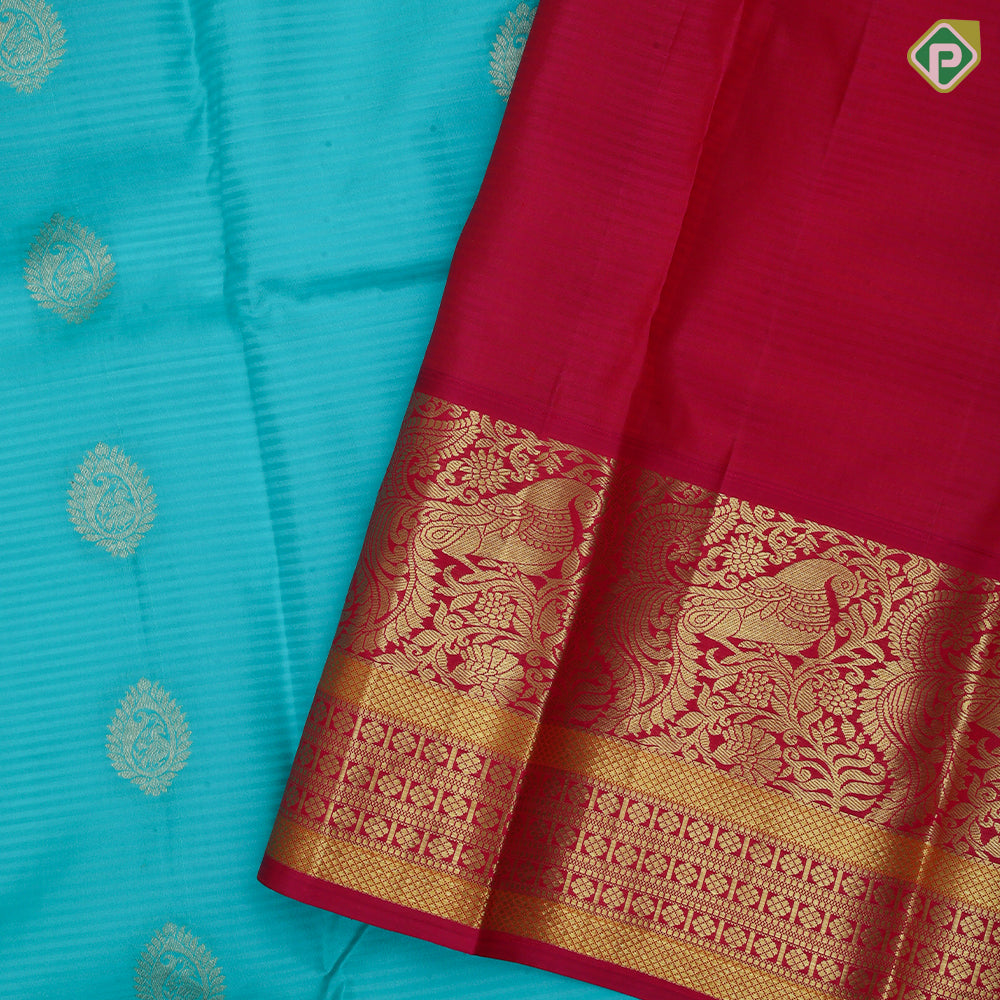 Sea green gold zari thilagam butta contrast pink gold zari peacock border traditional silk saree