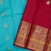 Sea green gold zari thilagam butta contrast pink gold zari peacock border traditional silk saree