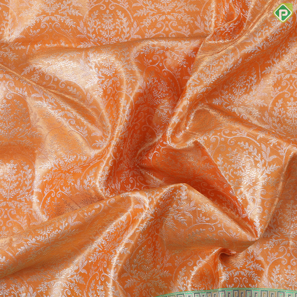 Honey orange silver zari floral creeper design contrast parrot green border grand bridal tissue silk saree