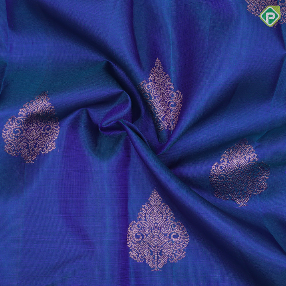 Peacock blue copper zari fancy thilagam butta design self color copper zari spinning edge border traditional silk saree