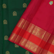 Bottle green gold zari arch and double peacock butta red gold zari elephant and arch retta pett border silk saree