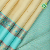 creamy sandal gold zari small round butta contrast sea blue rettapet border traditional silk saree