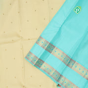 creamy sandal gold zari small round butta contrast sea blue rettapet border traditional silk saree