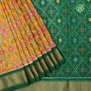 yellow base multi color ikkat design contrast green gold zari diamond border ikkat silk saree