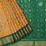 yellow base multi color ikkat design contrast green gold zari diamond border ikkat silk saree