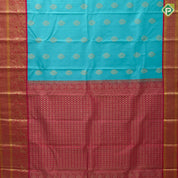 Sea green gold zari thilagam butta contrast pink gold zari peacock border traditional silk saree
