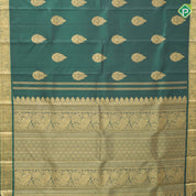 Bottle green gold zari fancy thilagam butta design self color gold zari peacock elephant butts edge border traditional silk saree