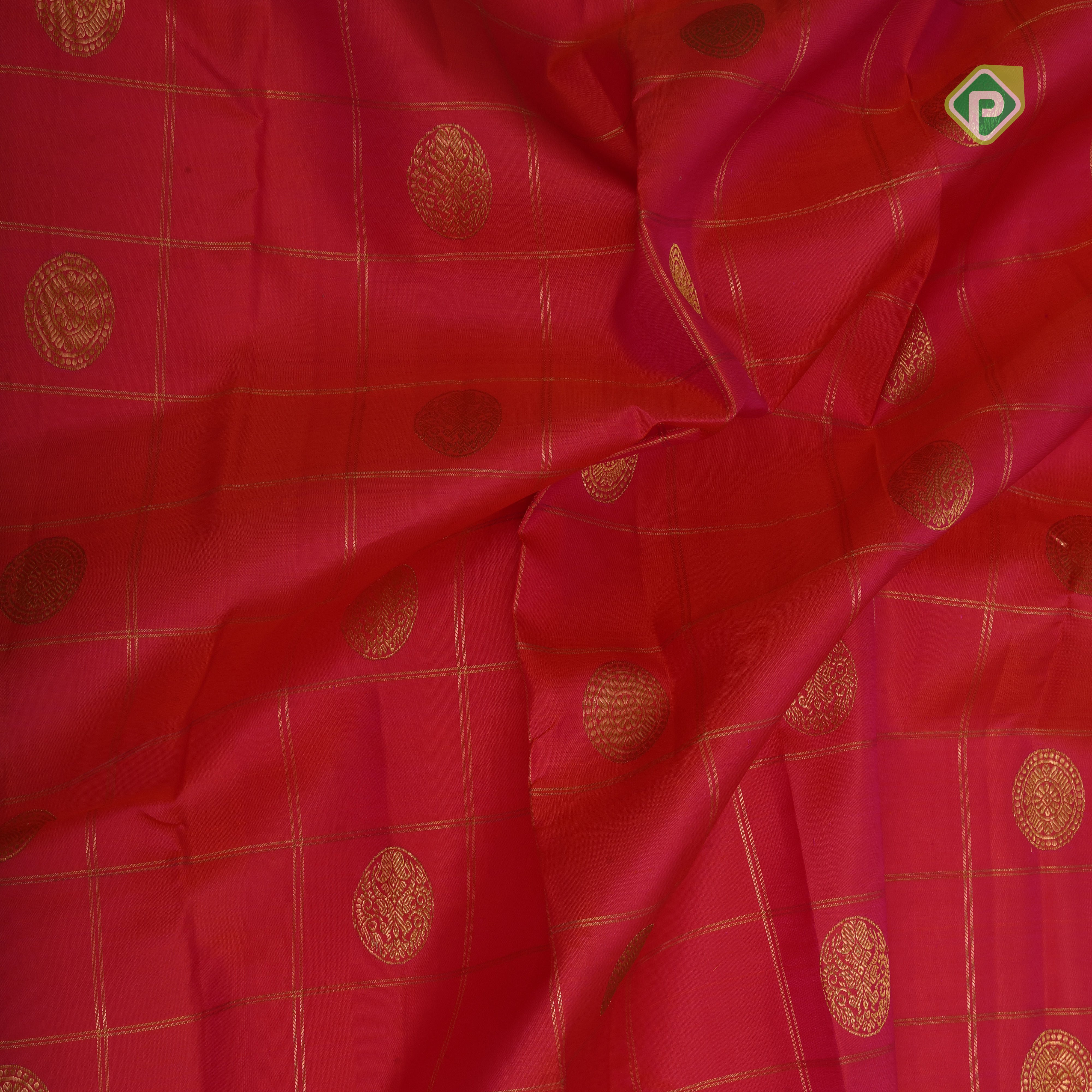 tomato red gold zari checked self design round butta contrast rexona green gold zari border traditional silk saree