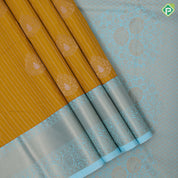 Mustard yellow gold zari stripes big thilagam butta pista green gold zari rangoli design border art silk saree