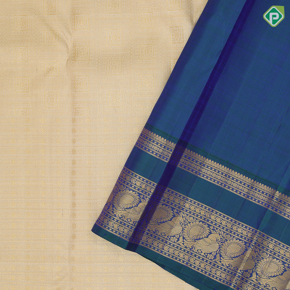 creamy sandal gold zari velthari and checks design peacock blue gold zari peacock butta retta pett border traditional silk saree