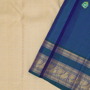 creamy sandal gold zari velthari and checks design peacock blue gold zari peacock butta retta pett border traditional silk saree