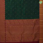 Dark green gold zari rudraksham butta design maroon gold zari velthari lines turning border traditional silk saree