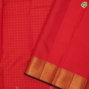 Flame red gold zari kattam checks design parrot butta padded self gold zari bavanji edge border traditional silk saree