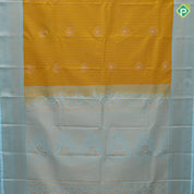 Mustard yellow gold zari stripes big thilagam butta pista green gold zari rangoli design border art silk saree