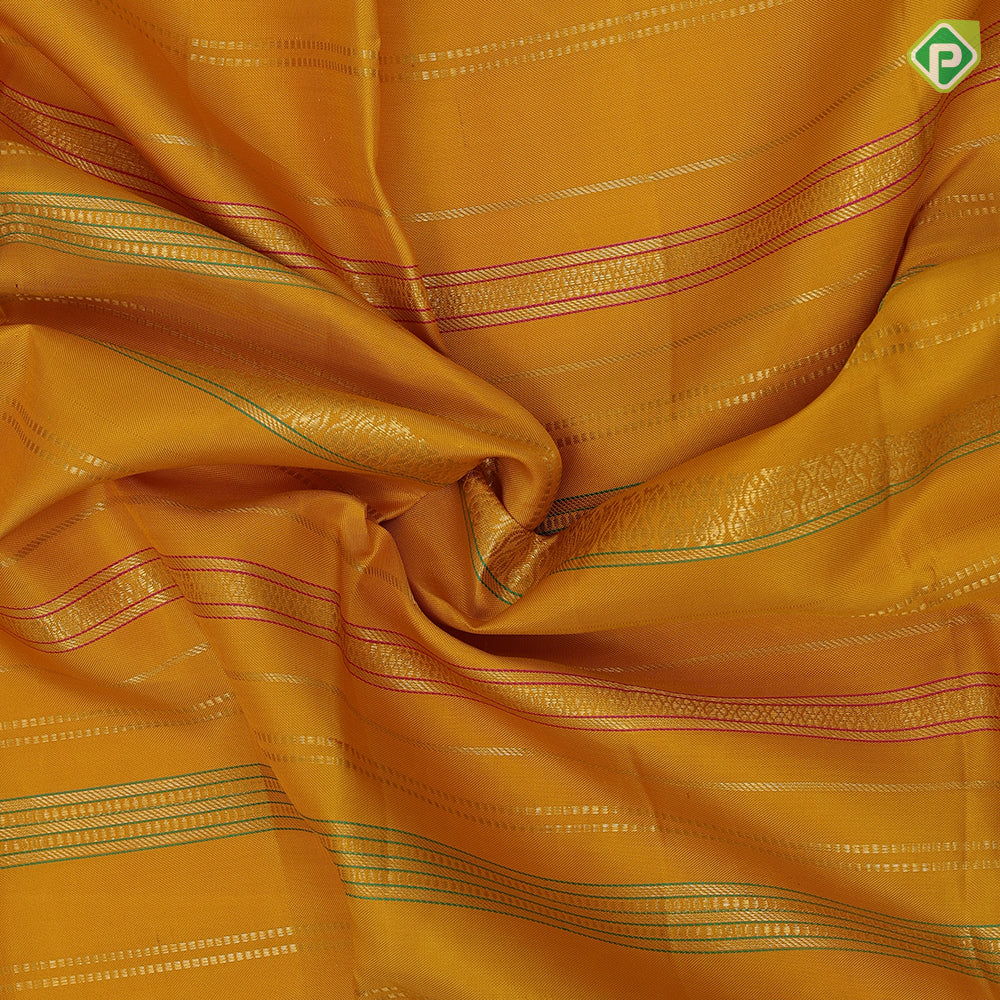 Golden yellow silk thread and gold zari velthari lines self gold zari thoranam design green edge border vintage silk saree