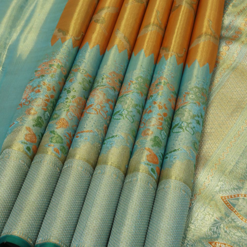 Orange silver zari swan meena work contrast green jaamthani border bridal tissue silk saree