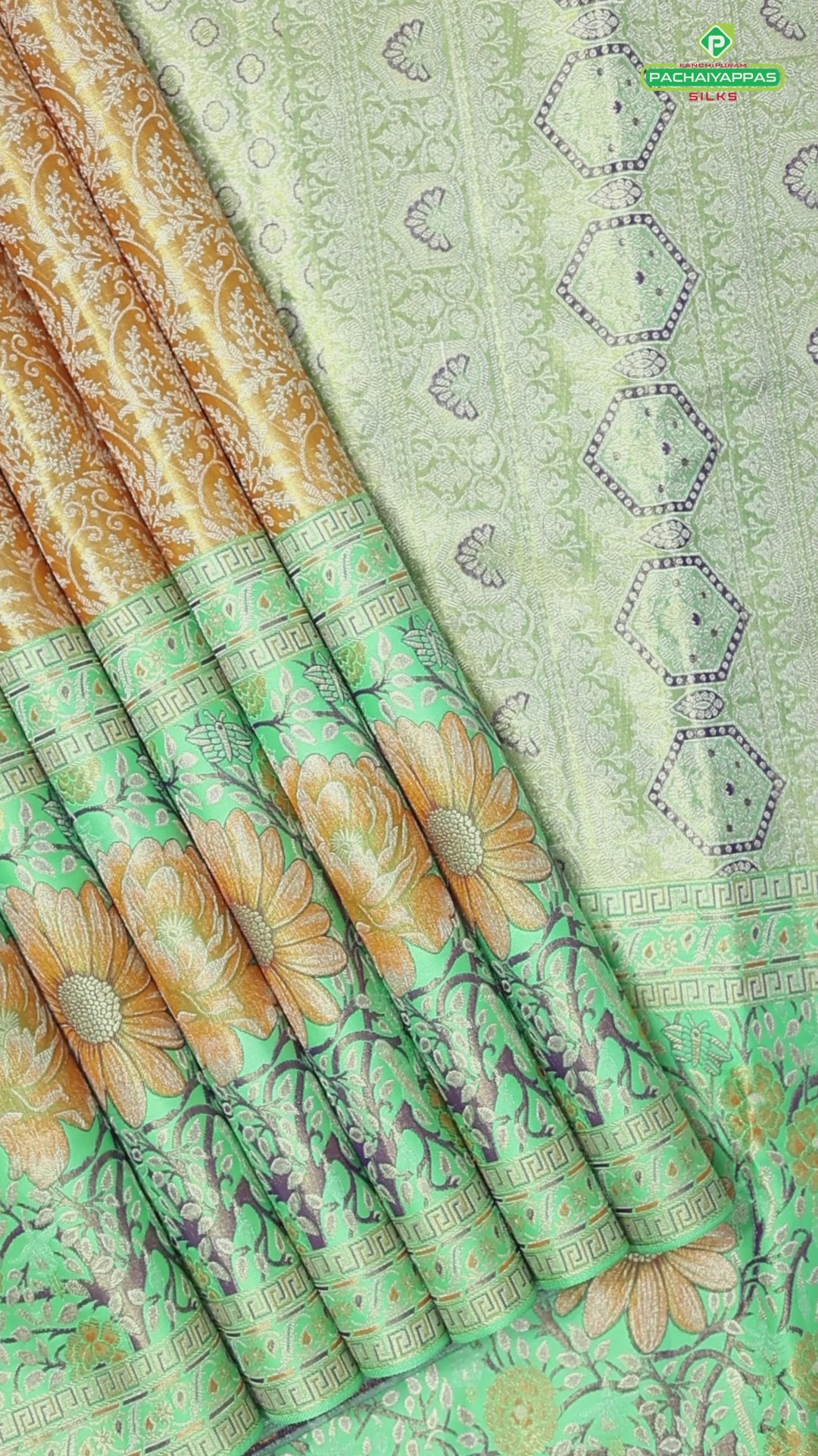 Honey orange silver zari floral creeper design contrast parrot green border grand bridal tissue silk saree