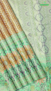 Honey orange silver zari floral creeper design contrast parrot green border grand bridal tissue silk saree
