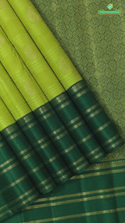 Lemon yellow with mango butta design dark green gold zari multi lines border Traditional silk saree