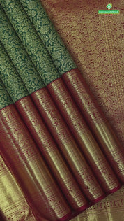 Dark green with gold zari grand floral design contrast maroon red gold zari border grand brocade bridal silk saree