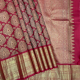 Maroon Red With Gold Zari And Green Silk Thread Thilagam Flower Design Self Colour With Gold Zari Peacock Retta Pet Border Exclusive Bridal Silk Saree