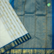 Cream White With Gold Zari Self Designed Thilagam Butta Motifs And Rama Blue With Gold Zari Peacock Butta Motifs Border Traditional Silk Saree