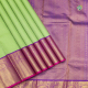 Leaf Green With Blue Colour Silk Thread Small Checked Window Panel Design And Purple Pink With Gold Zari Peacock Chakram Rangoli And Zig Zag Border Traditional Silk Saree