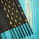 Luxury Black With Gold Zari Peacock And Rudraksham Butta Motifs With Yellow Colour Silk Thread Stripes And Peacock Blue With Gold Zari Lines Border Traditional Silk Saree