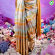 Lavender Base With Multi Colour Sea Shore Waves And Flower Design Weaved And Golden Yellow With Silver Zari Mango Two Lines Mid Gap Border Prismatic Luminescence Christmas Edition Tissue Silk Saree